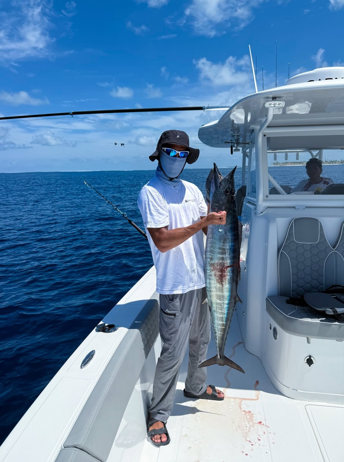Guest holding a wahoo caught trolling offshore in South Ari Atoll