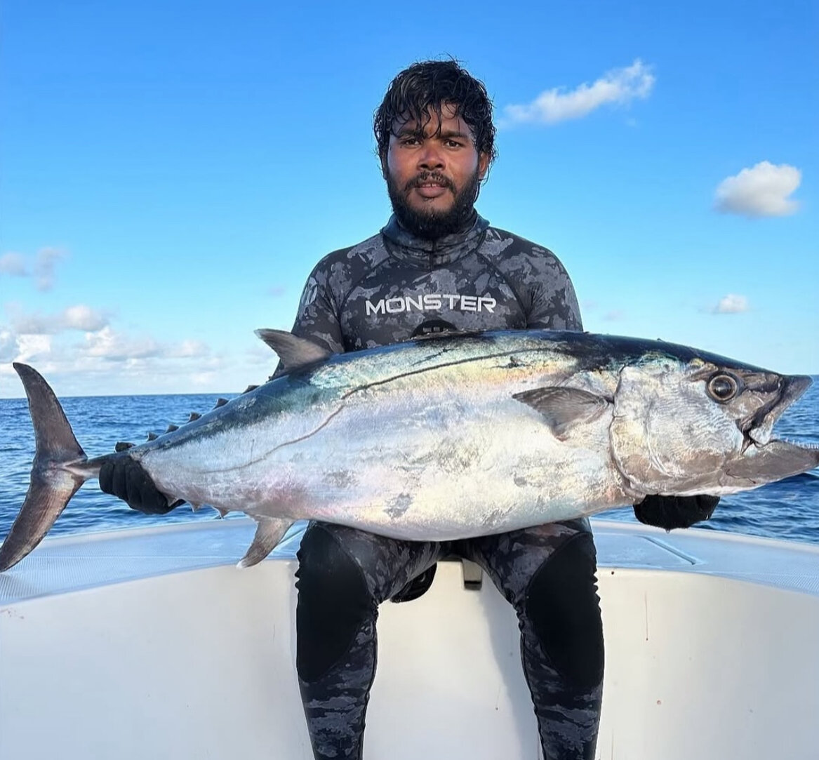 Captain holding a dogtooth tuna caught deep jigging in South Ari Atoll