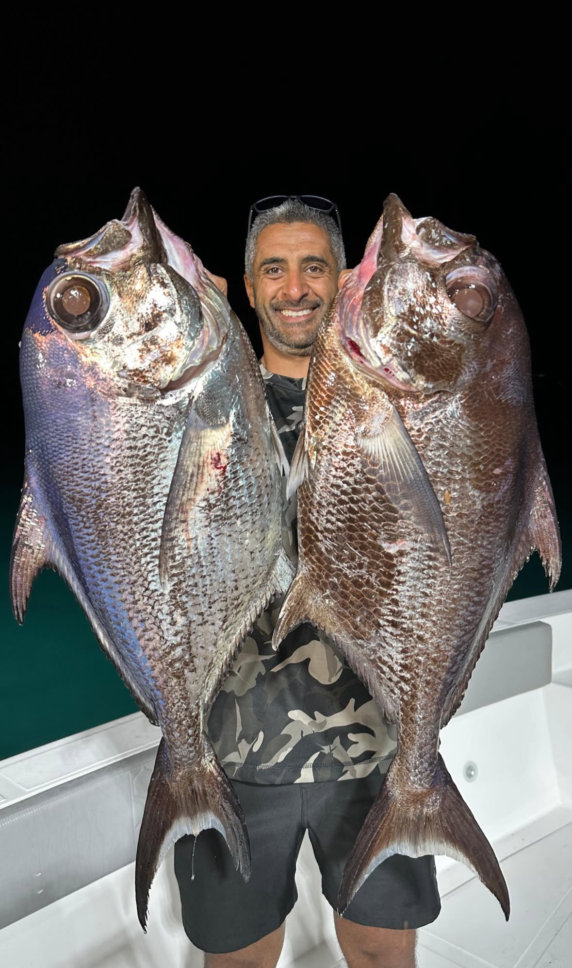 Guest with two big snappers caught deep jigging at night with Spear Maldives