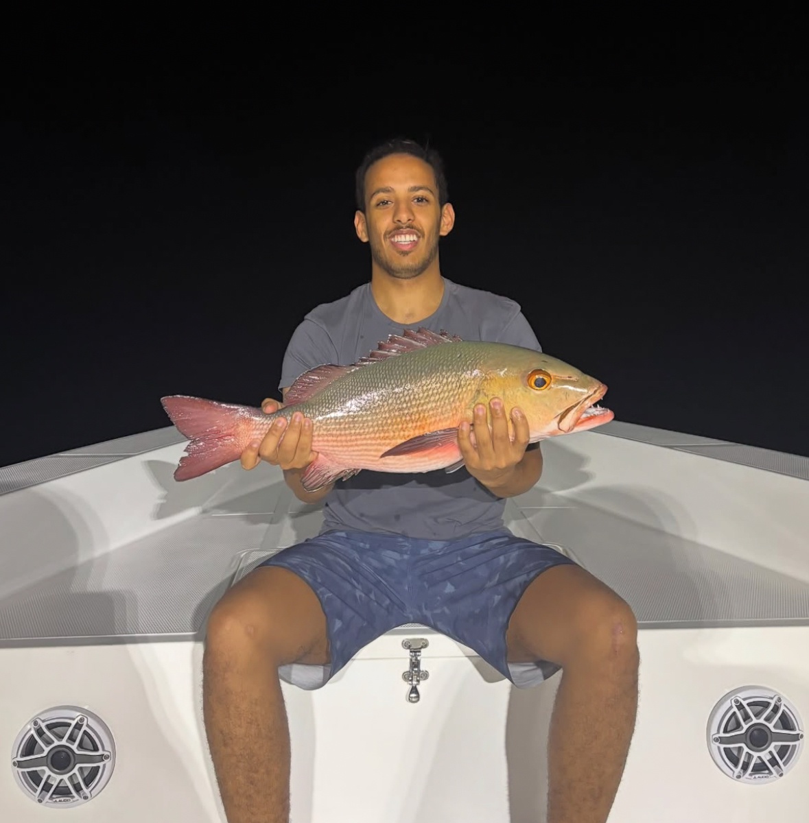 Guest with a green jobfish caught night fishing in South Ari Atoll