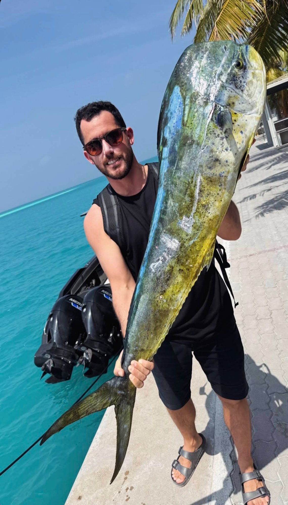 Guest holding mahi mahi caught in Maldives